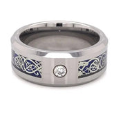Silver ring with blue and white designs and a cubic zirconia on a white background